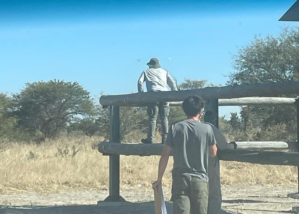 Professor Mahupeleng, myself, and Prince scanning the bush for the next waterhole