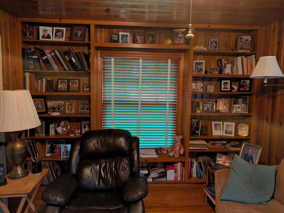 Dave Clark keeps photos of all 28 of his exchange students on the wall.
