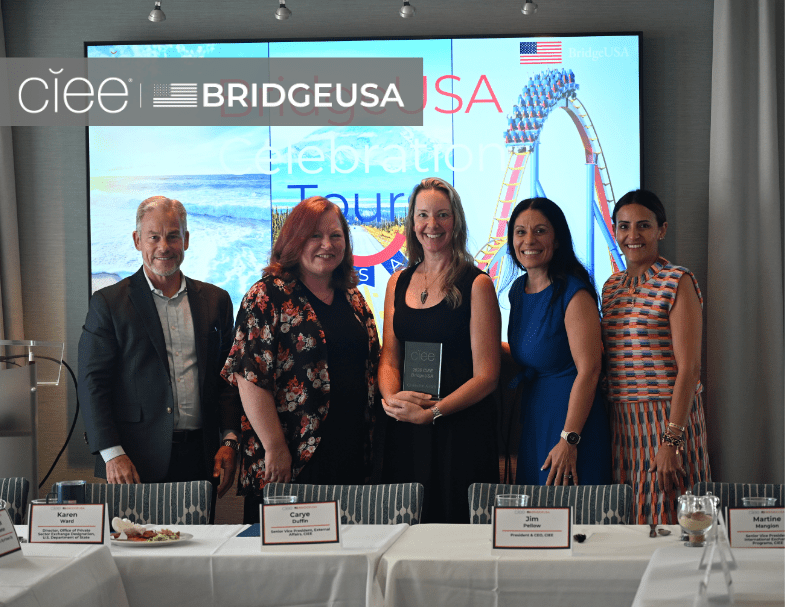 CIEE and BridgeUSA representatives pose with an award recipient during a BridgeUSA Celebration Tour event.